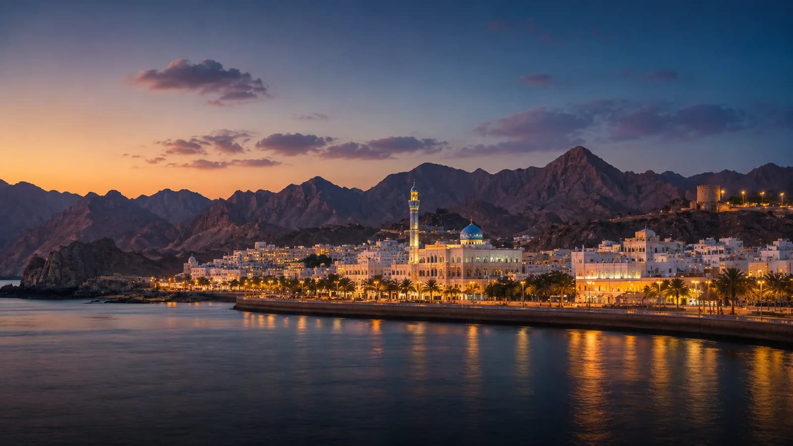 Muscat's Mutrah Corniche at dusk with the Hajar Mountains behind — premium private chauffeur and transfer service