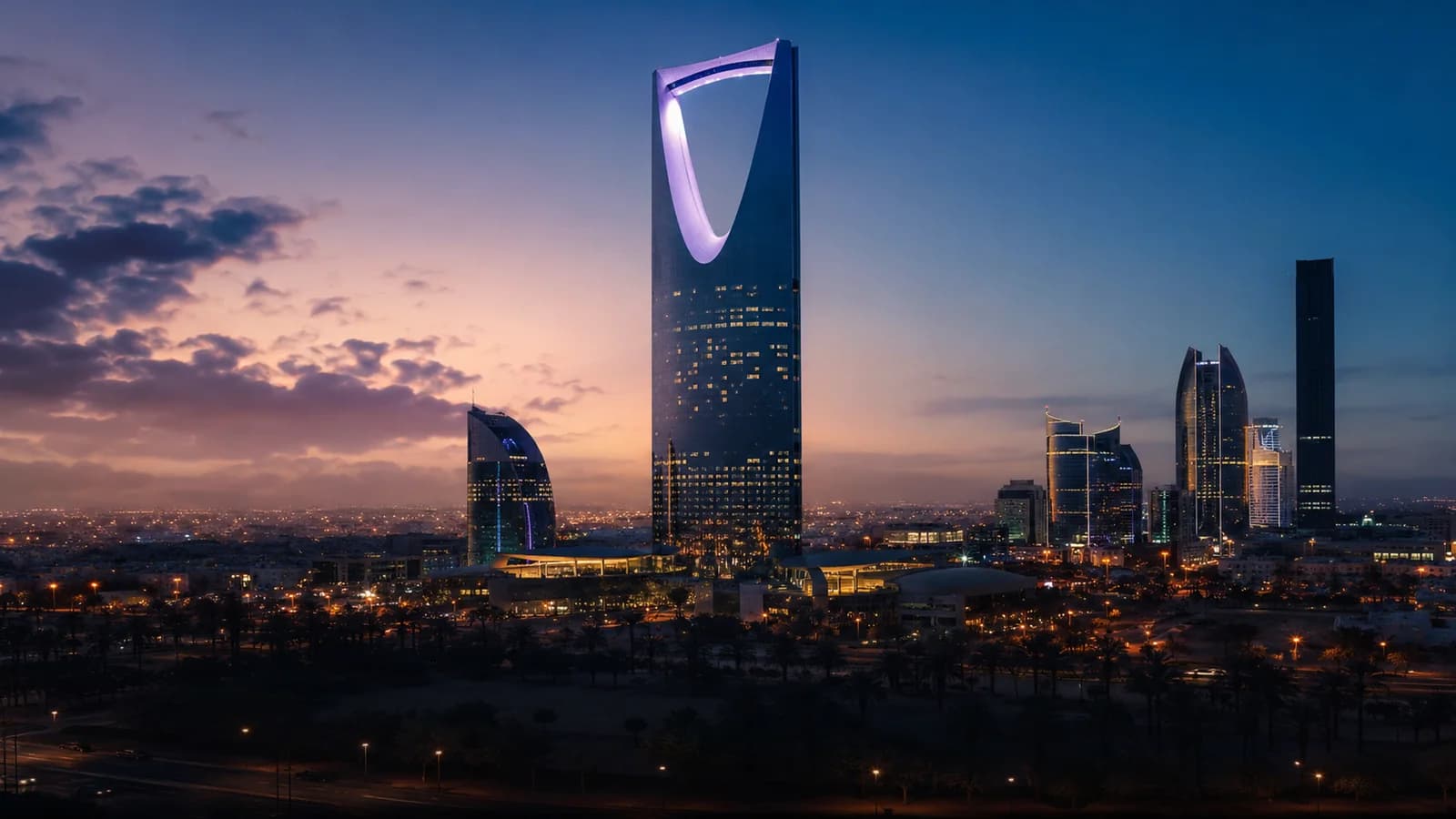 Riyadh skyline at blue hour with the Kingdom Centre Tower — private chauffeur and taxi service in Saudi Arabia's capital